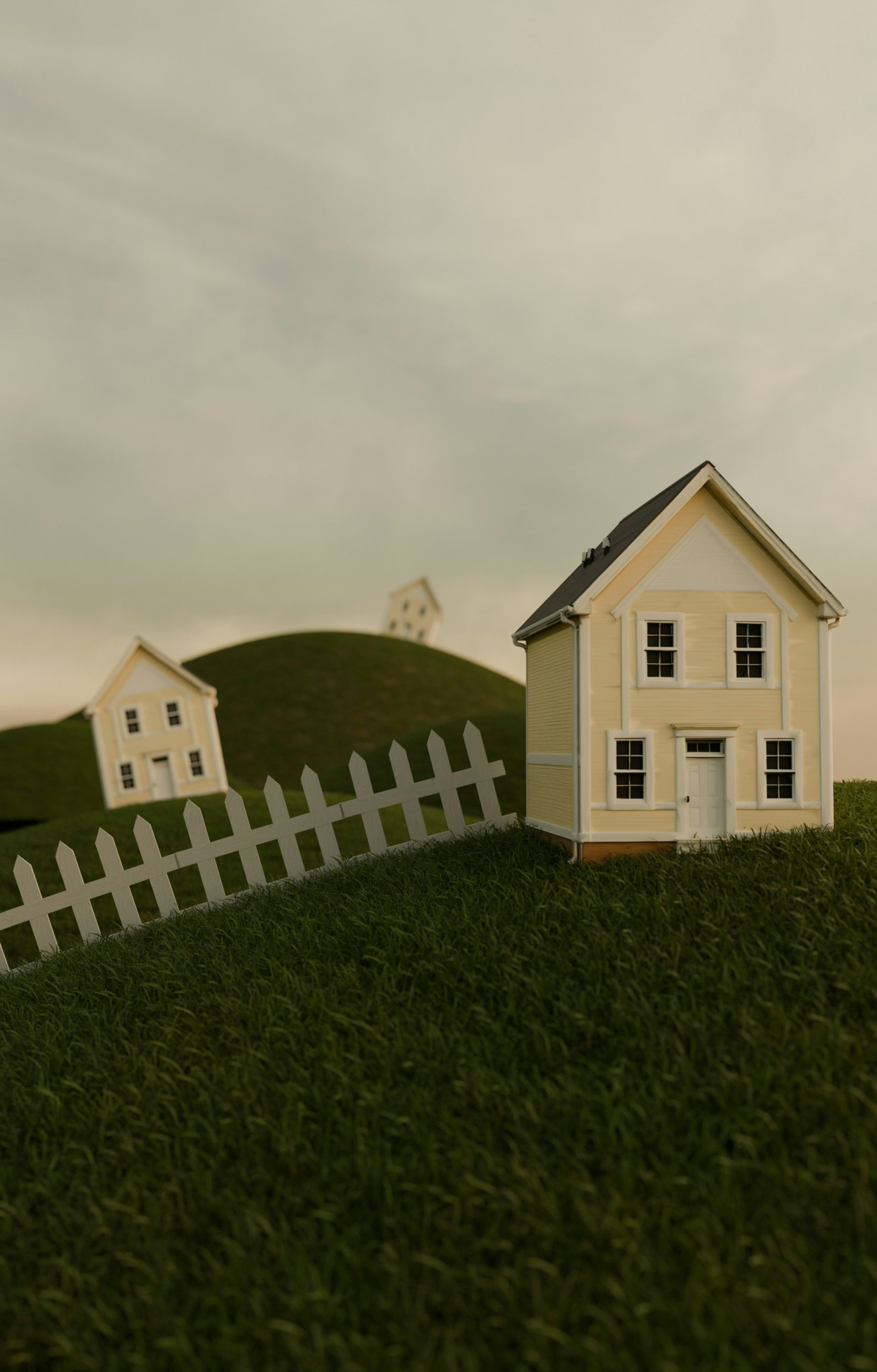 Miniature houses on green hills with a white picket fence
