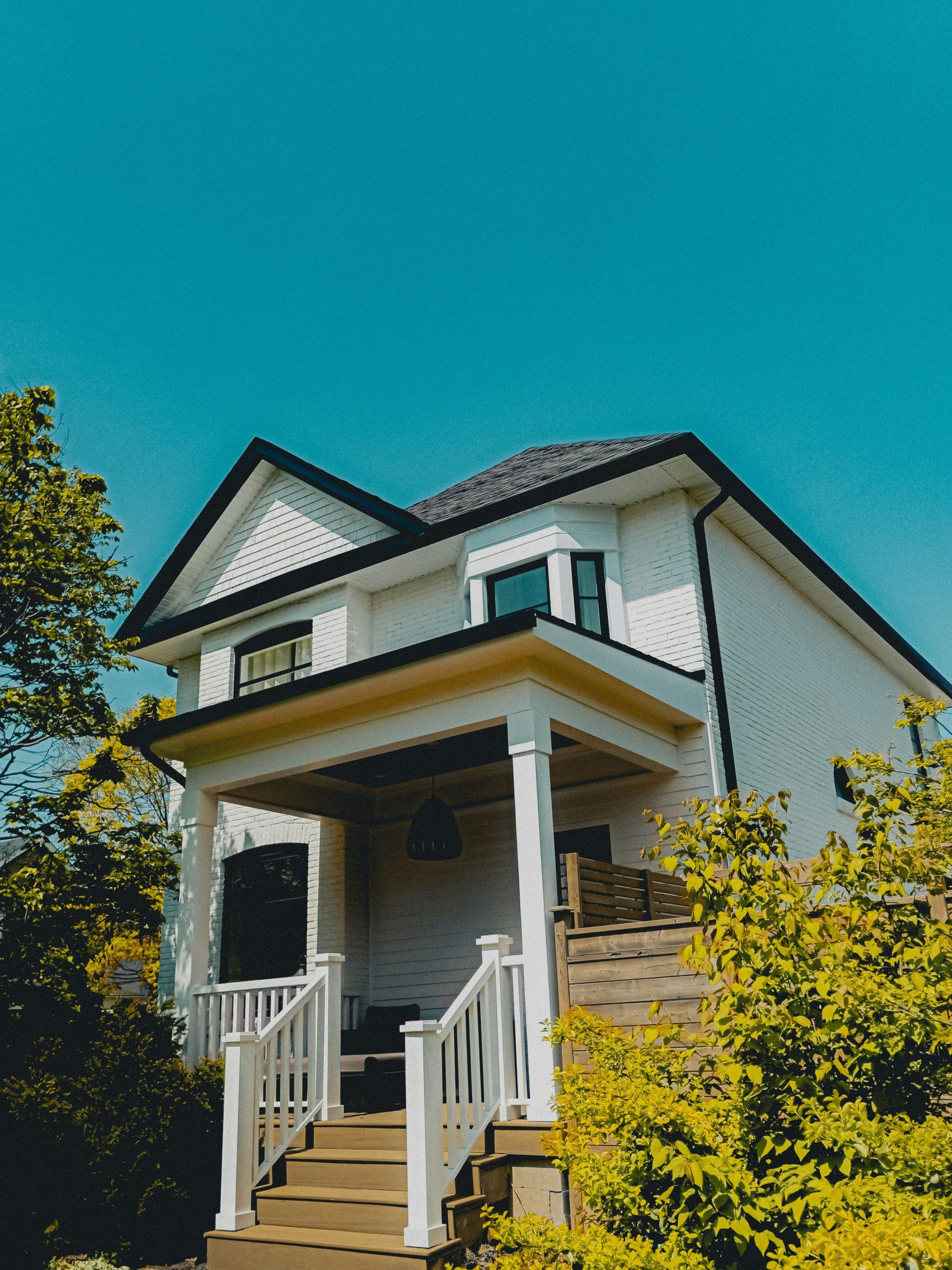 a white house with a porch and stairs